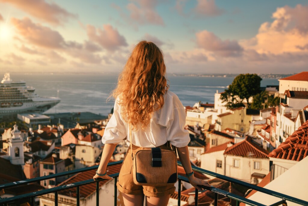young-female-standing-platform-surrounded-by-fences-observing-lisbon-daytime-portugal
