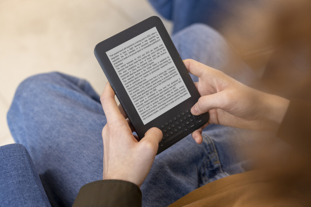 high-angle-man-reading-digital-magazine