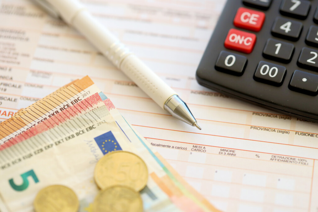 filling-italian-tax-form-process-with-pen-calculator-euro-money-bills-close-up-tax-paying