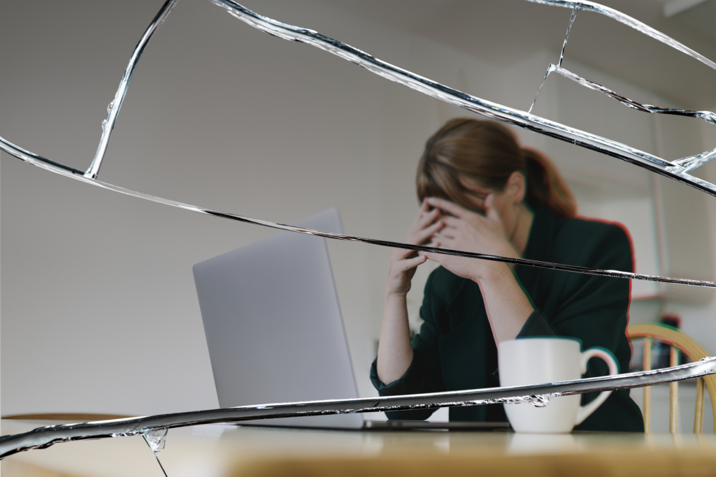 stressed-woman-sitting-front-laptop-with-cracked-glass-effect